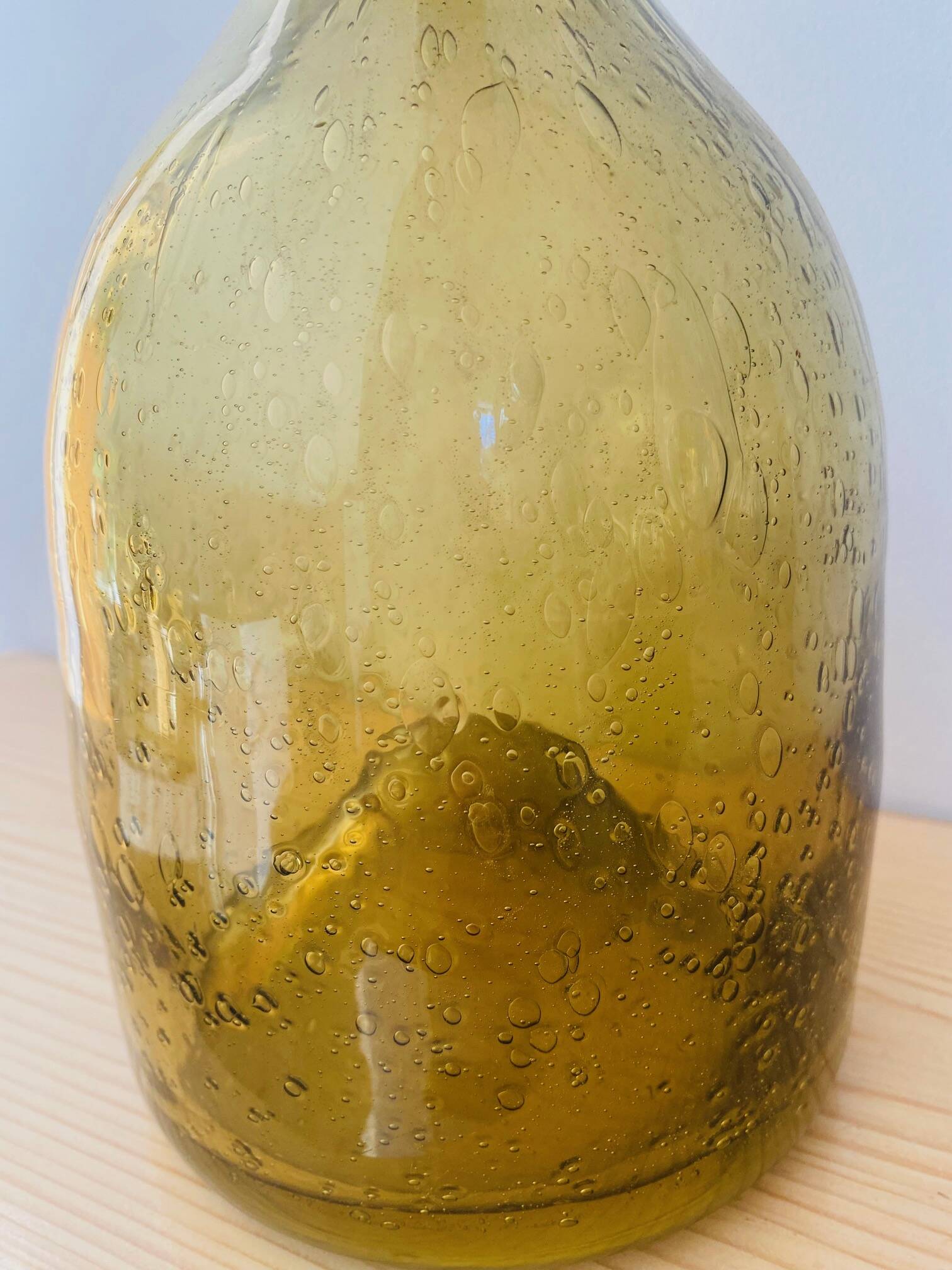Amber colored Biot bubble glass bottle