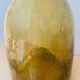 Amber colored Biot bubble glass bottle