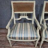 a pair of caned armchairs in the Louis XVI style, elegant and full of charm.