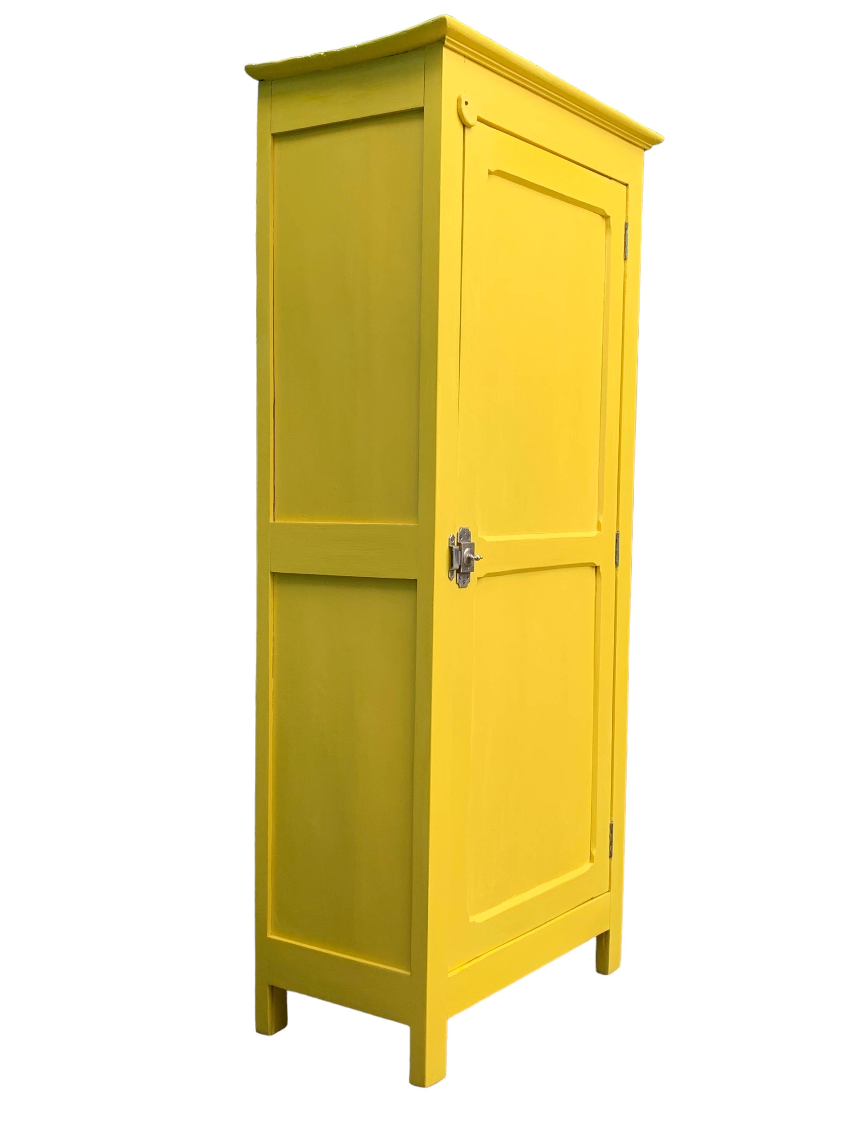 Antique powder yellow Parisian bonnetière wardrobe.