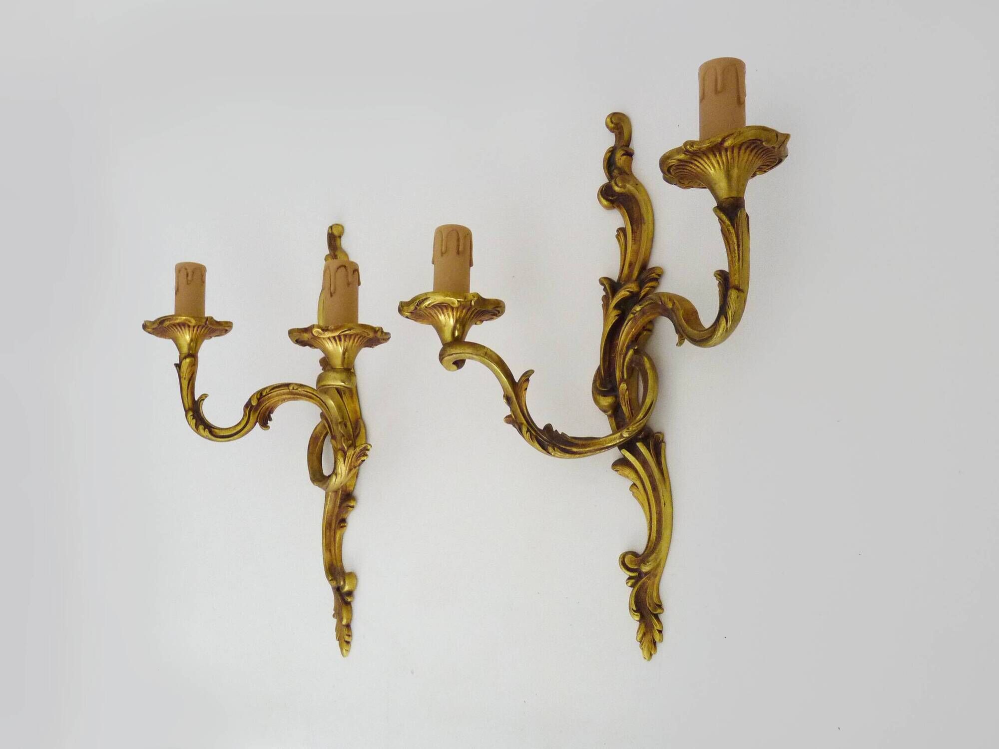 Antique pair of double-light bronze wall sconces with acanthus leaves. 1950s