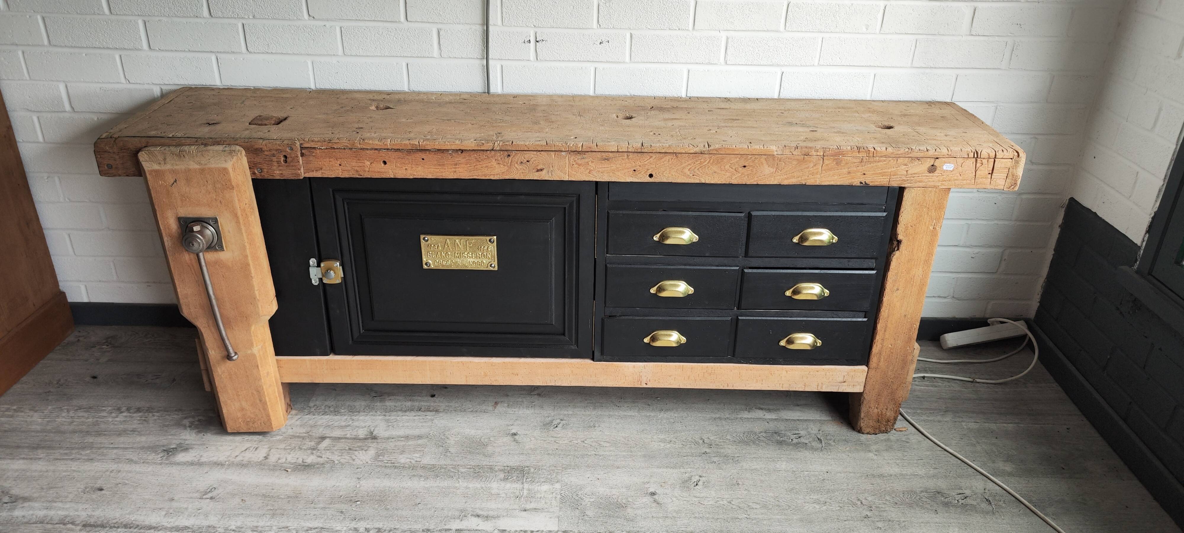 Old workbench furniture with six drawers and a door