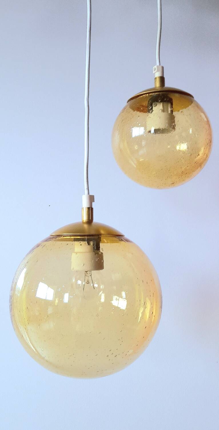 Set of 2 bubbled amber glass globe pendants