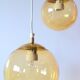 Set of 2 bubbled amber glass globe pendants