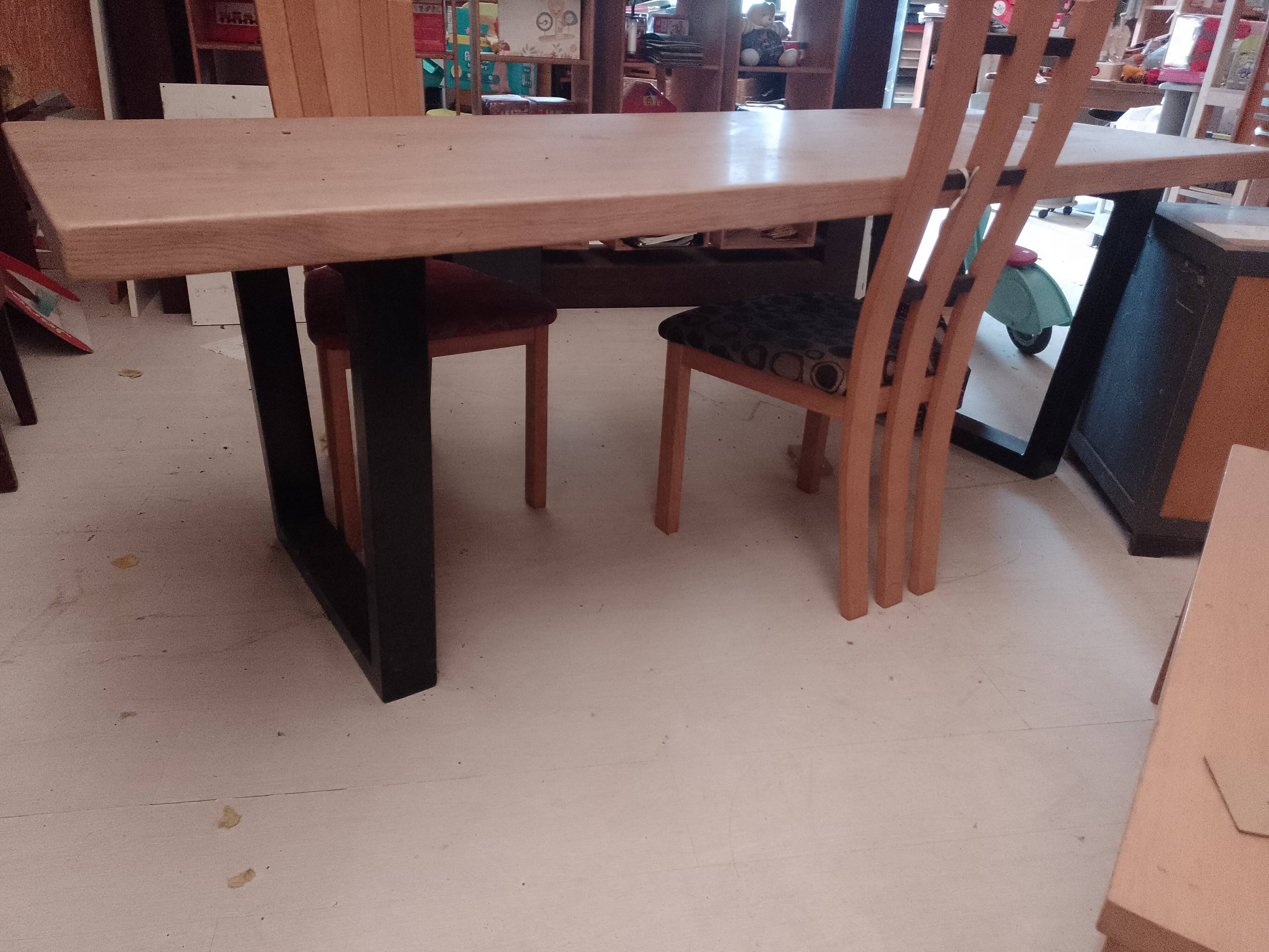 Modern table with metal legs and a natural varnished solid oak top