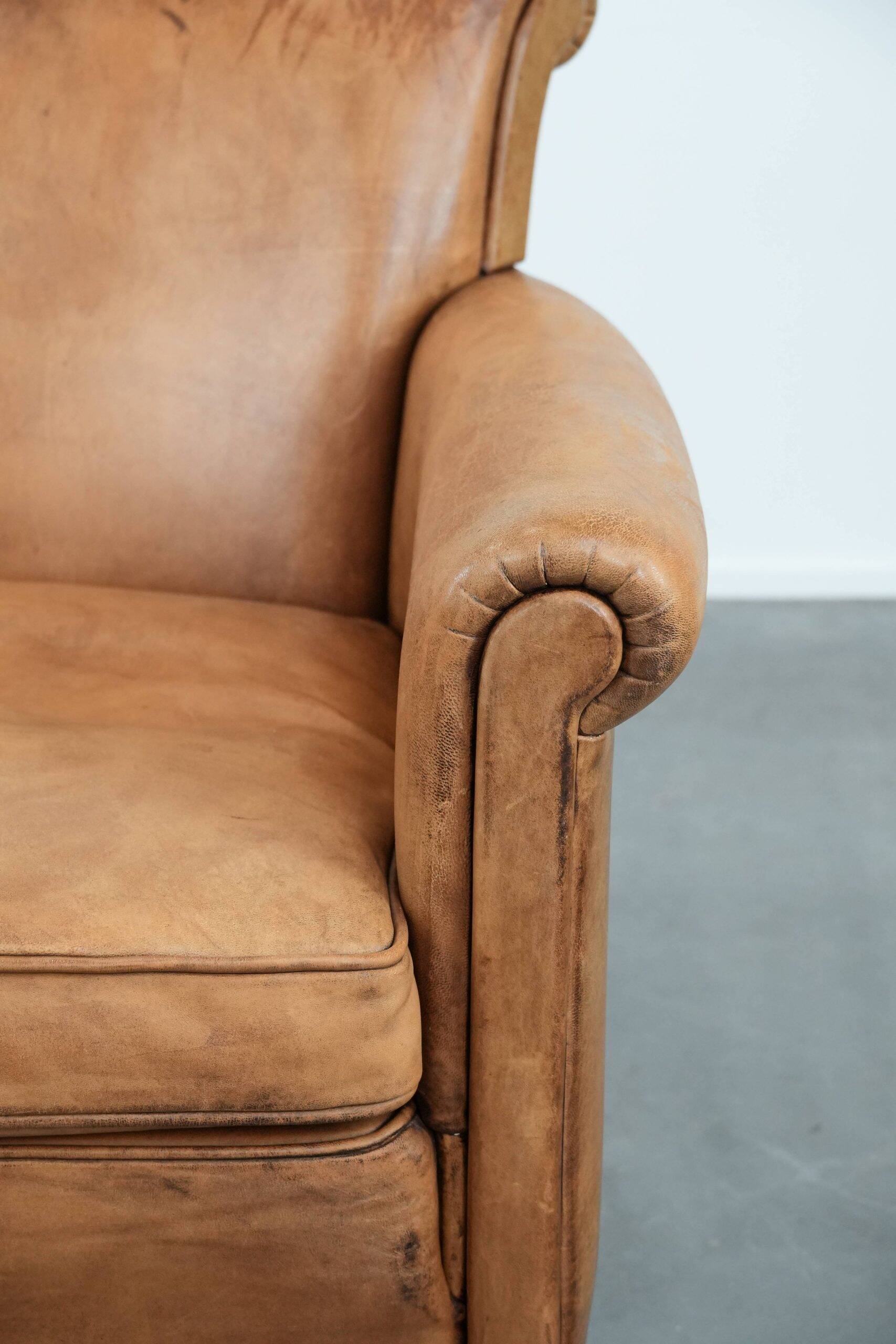 Beautiful subtle vintage sheepskin armchair with elegant legs