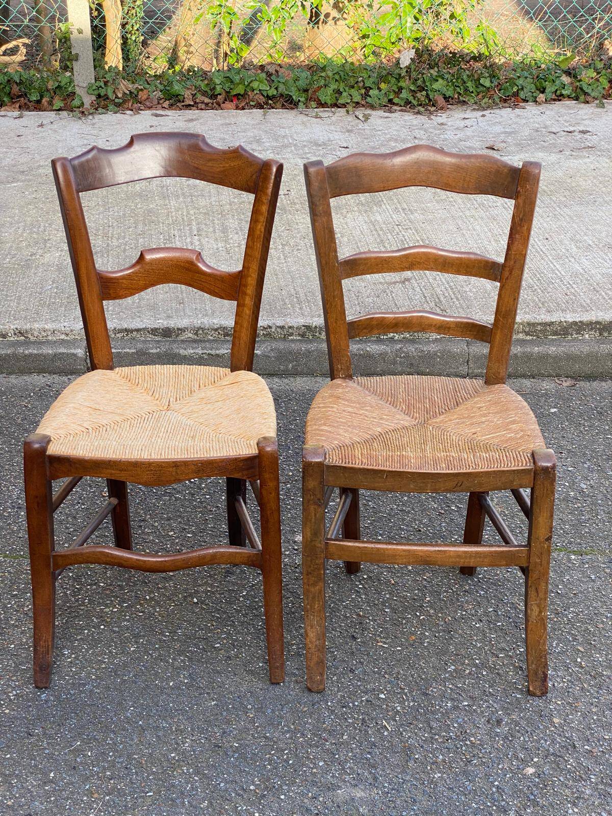2 solid oak carved and rush-seated chairs in the Louis Philippe style, 19th century.