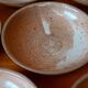 Set of 10 turned stoneware plates, pyritised and glazed, wabi-sabi brutalist.
