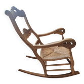 Oak rocking chair with a straw seat.