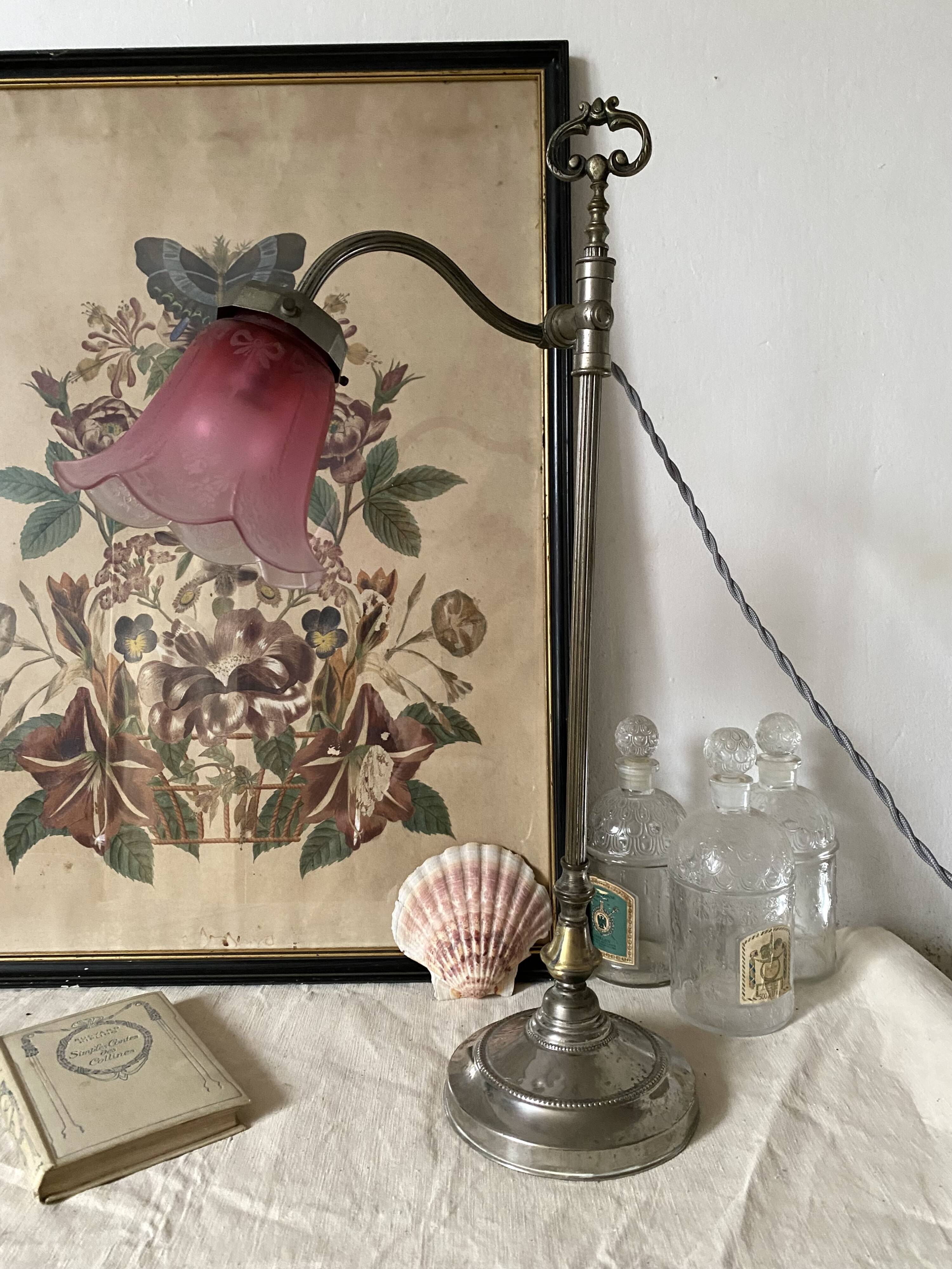 Antique jeweller's lamp, silver-plated base, frosted pink glass shade.