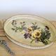 Oval metal decorative vintage tray with floral pattern.