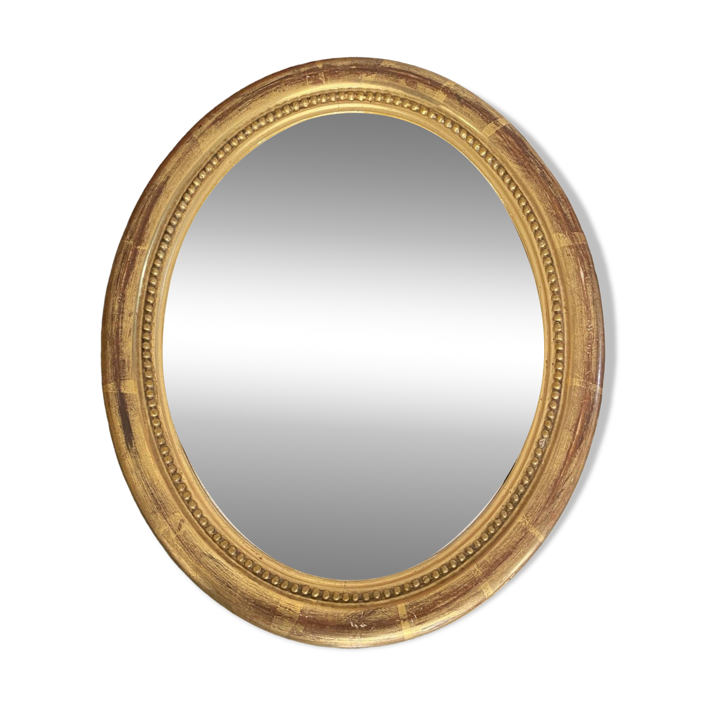 Oval mirror in gilded wood.