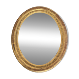 Oval mirror in gilded wood.