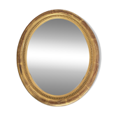 Oval mirror in gilded wood.
