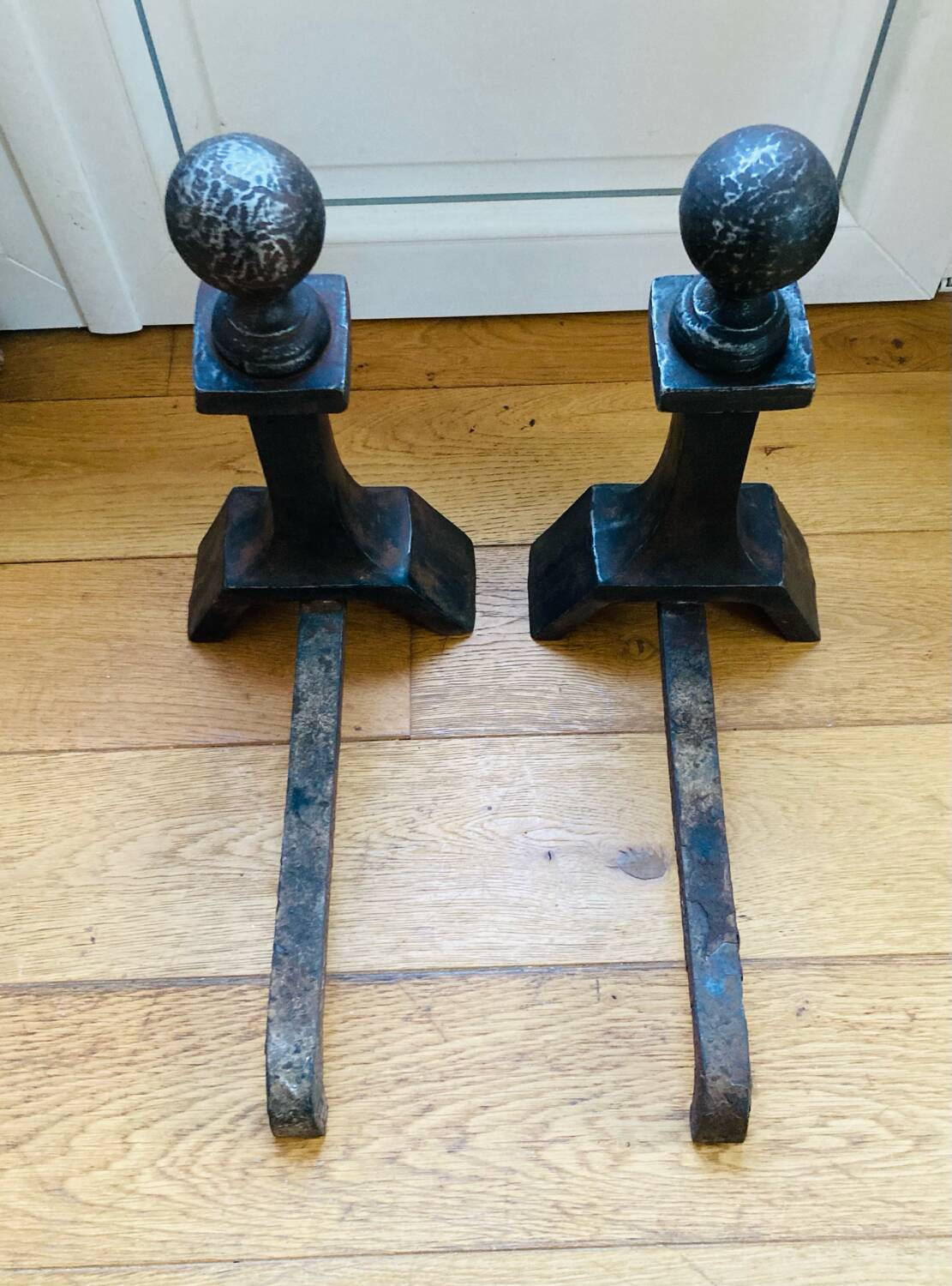 Pair of massive antique-style fire dogs in solid iron from the 20th century.