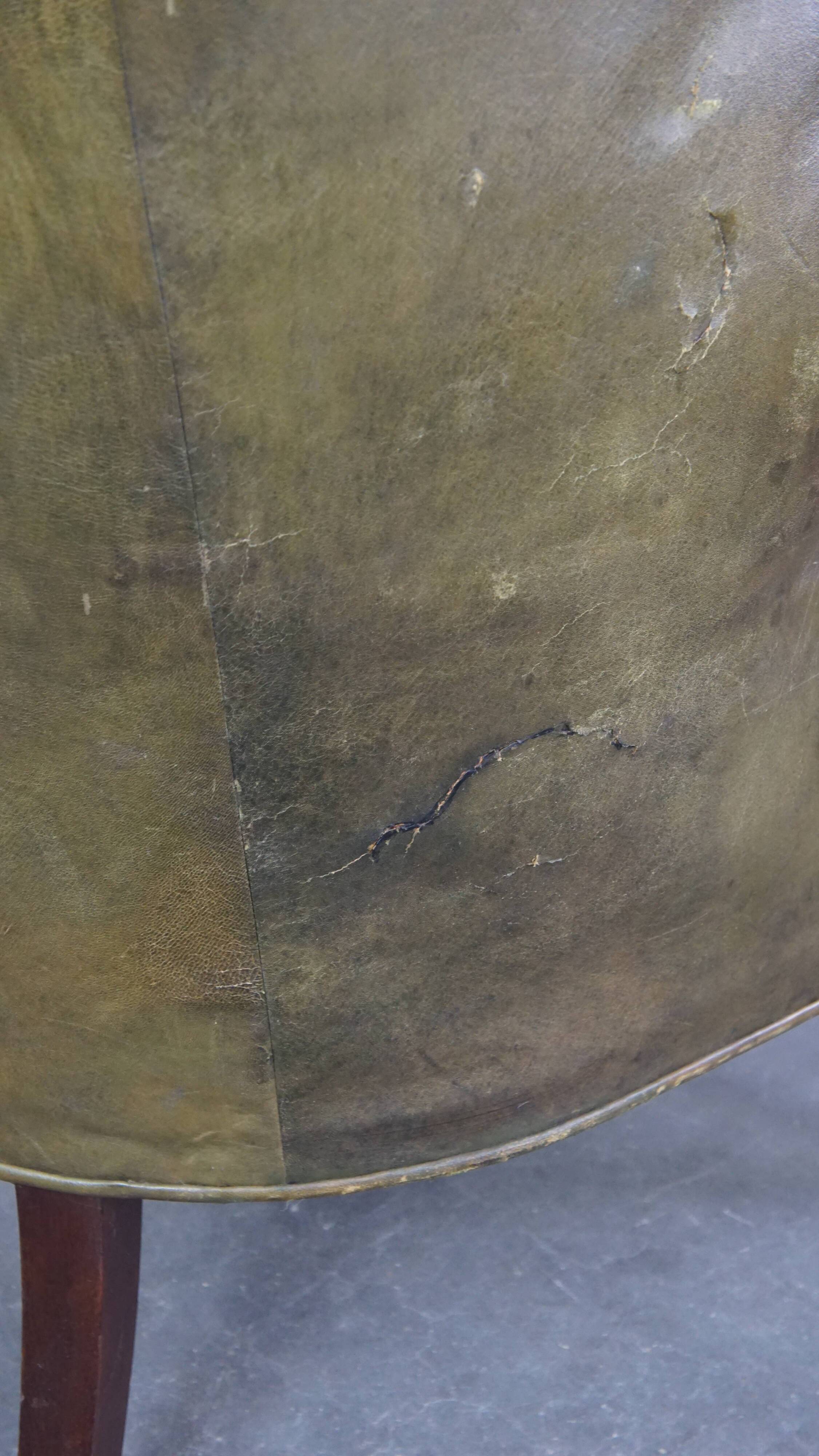Green antique barrel back wingback chair on wheels
