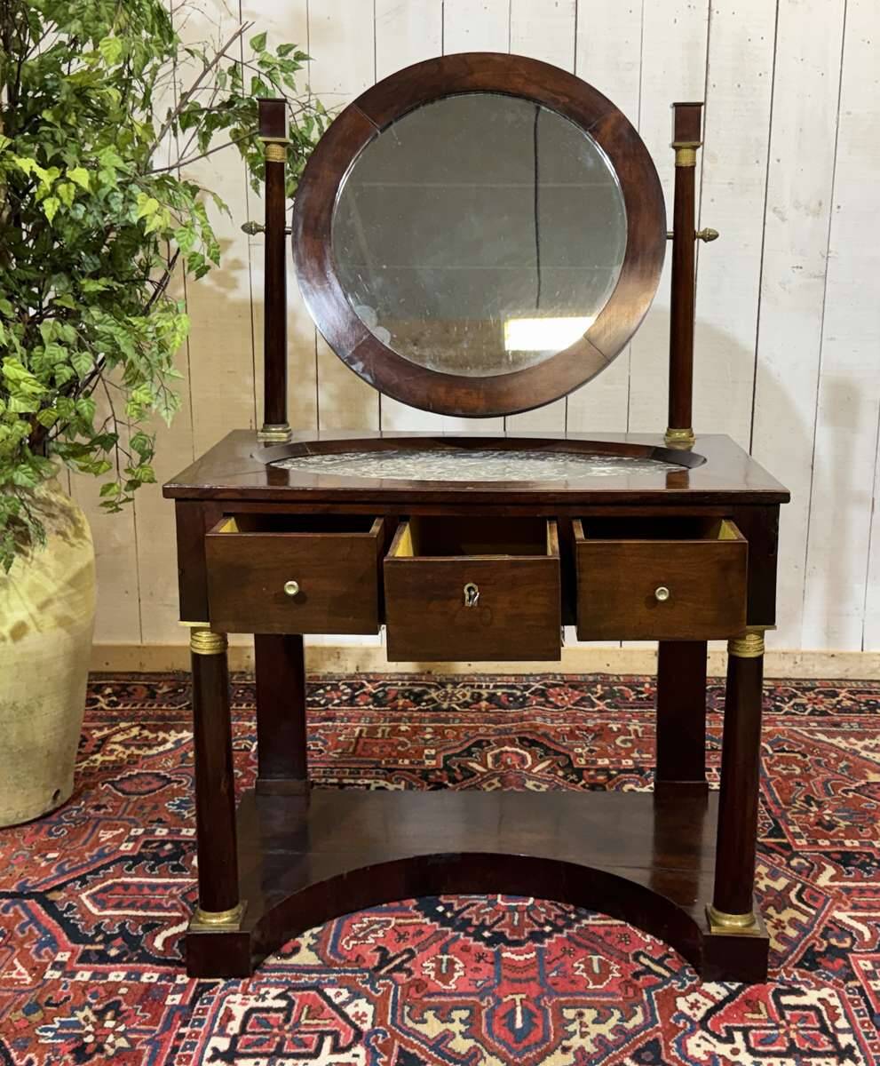 Empire hairdresser from the 19th century in mahogany with a marble top.