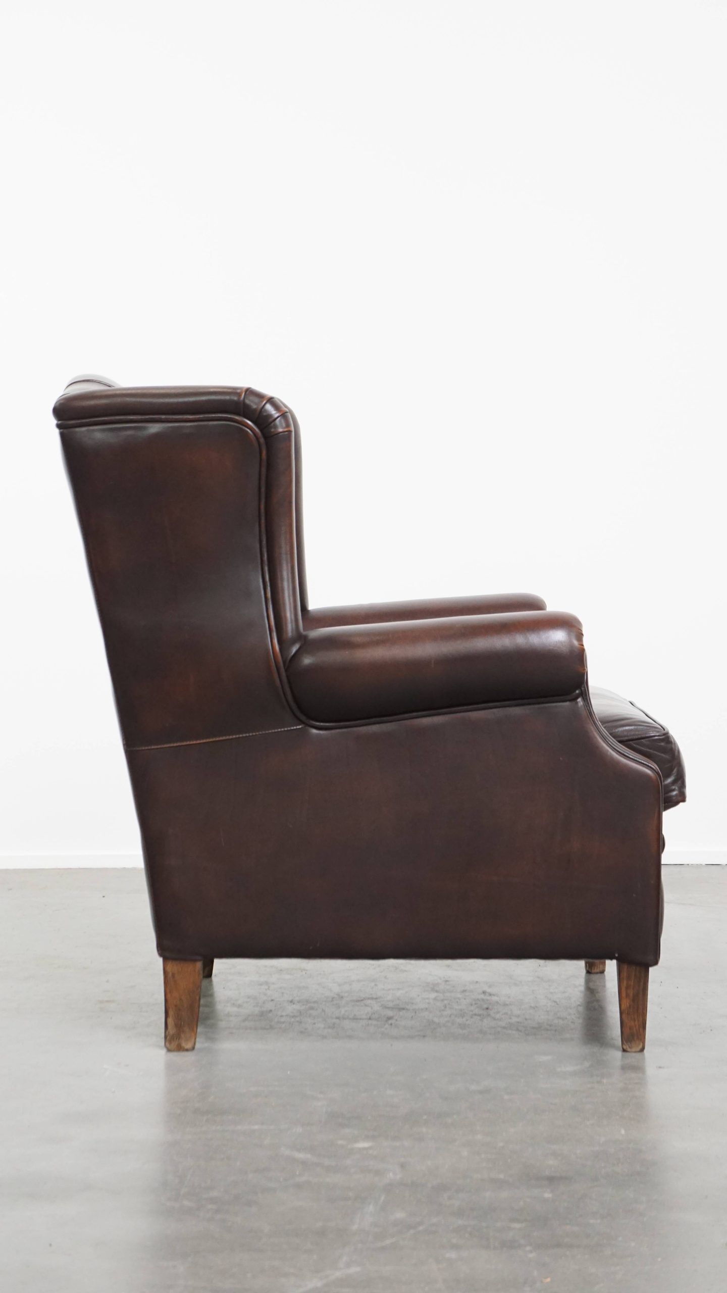 Very beautiful wing chair made of cowhide leather in English style