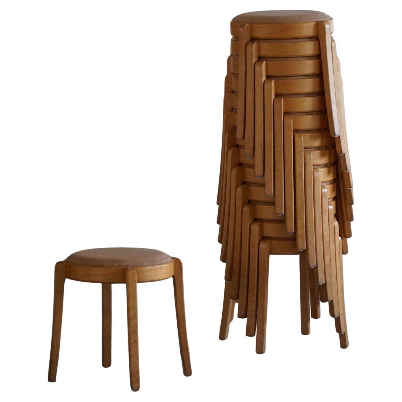 Set of 14 modern Swedish stackable stools in birch and hessian, 1980s.