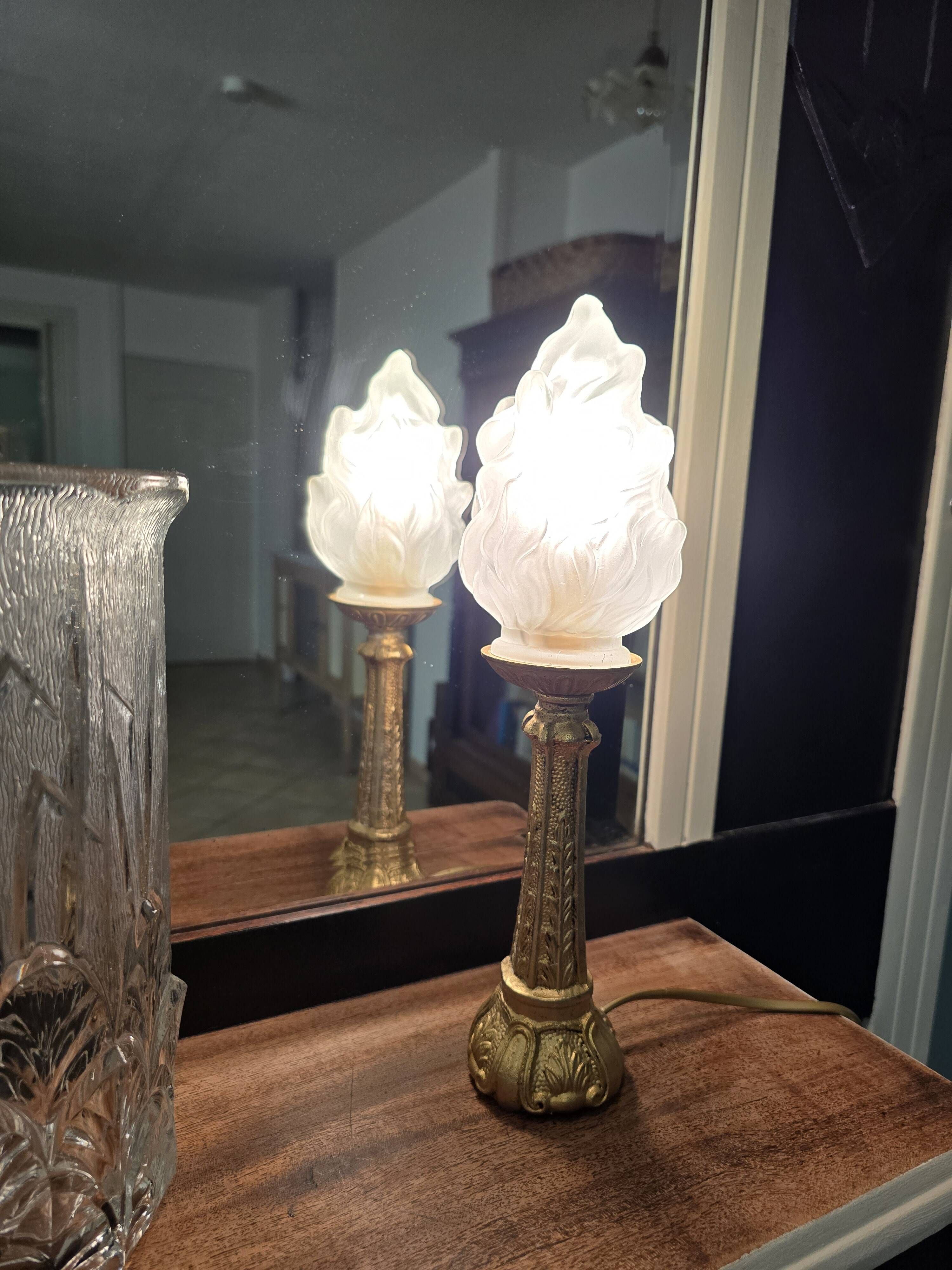 Table lamp with brass base and vintage flame globe