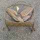 Vintage wrought iron magazine rack with flower pattern.