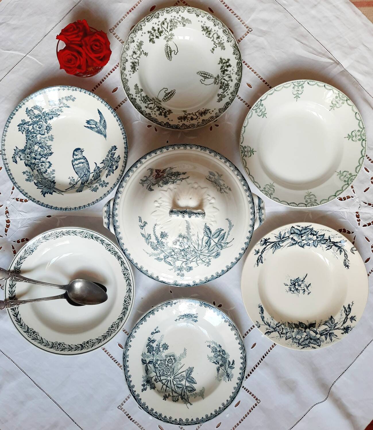 Old mismatched hollow plates in iron earth earthenware accompanied by a soup tureen