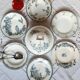 Old mismatched hollow plates in iron earth earthenware accompanied by a soup tureen