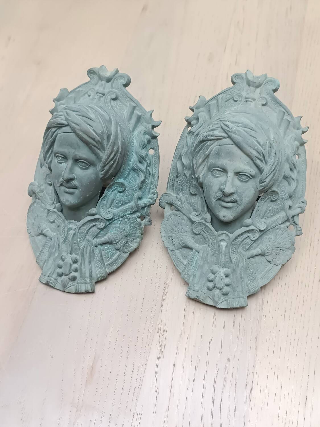 Bronze door knockers and billiard table corners