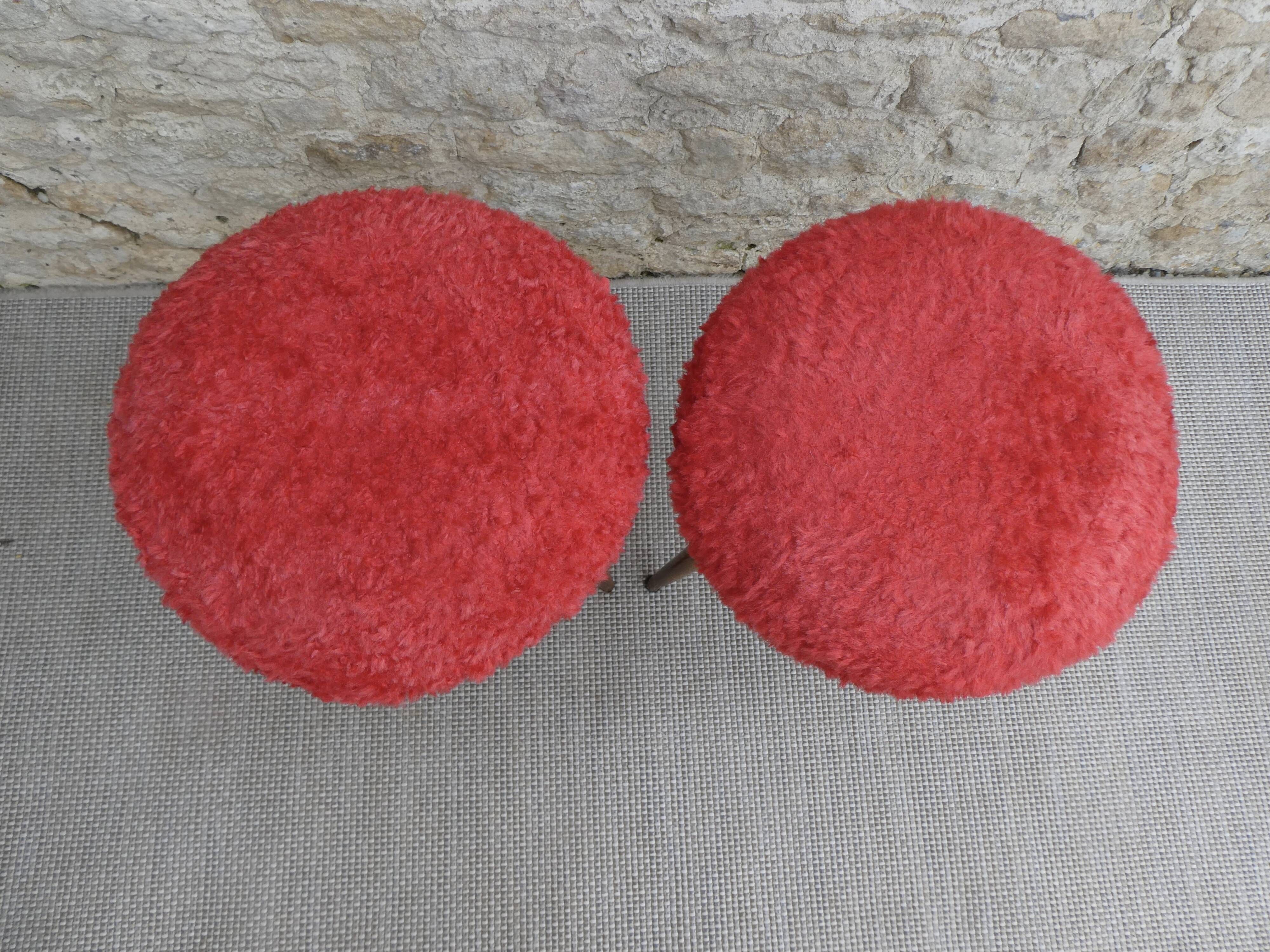 Pair of tripod stools, with tapered wooden feet and moumoute seat