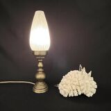 Old bronze or brass table lamp from the early 20th century with white streaked flame glass globe