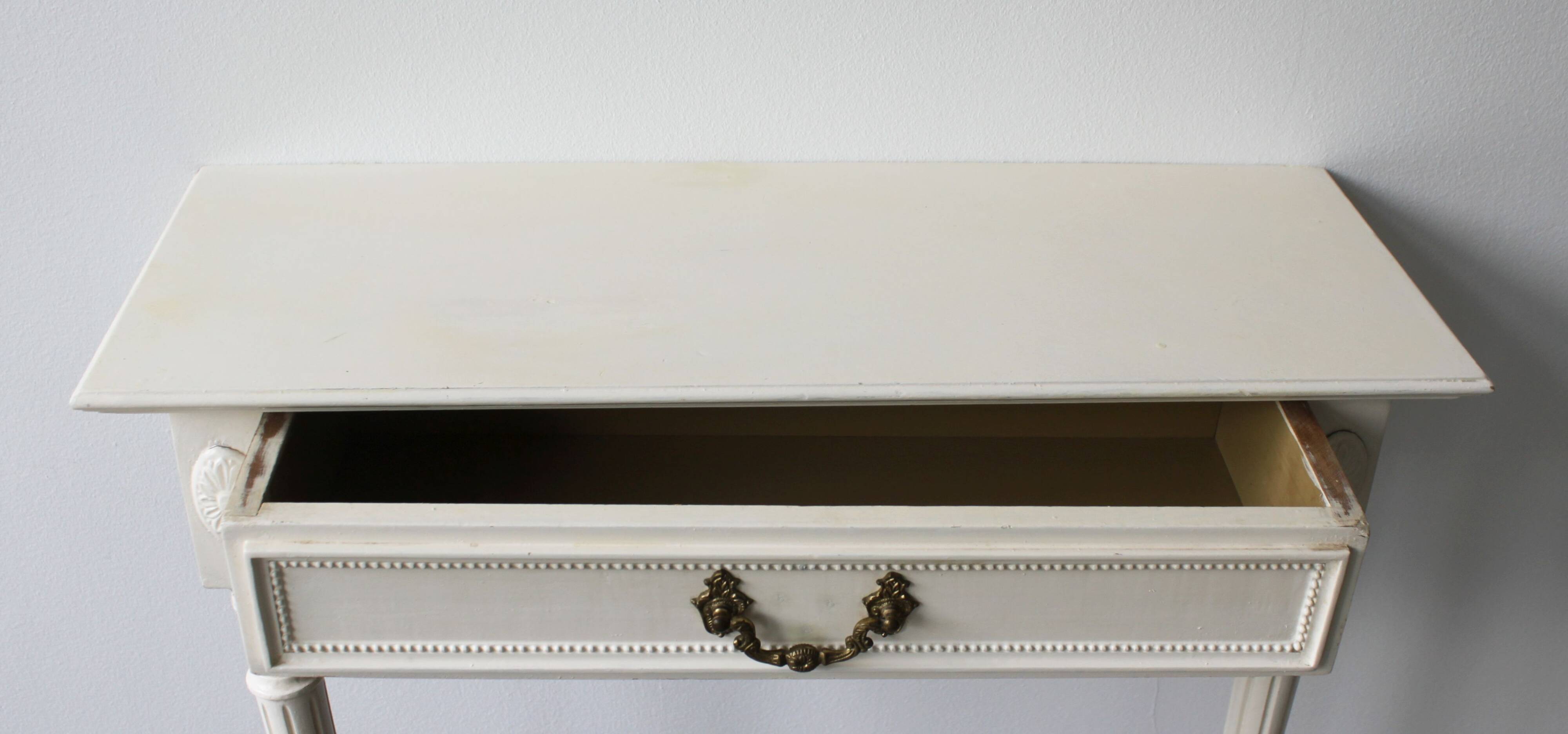 Two-legged wall console in Louis XVI style, painted wood.