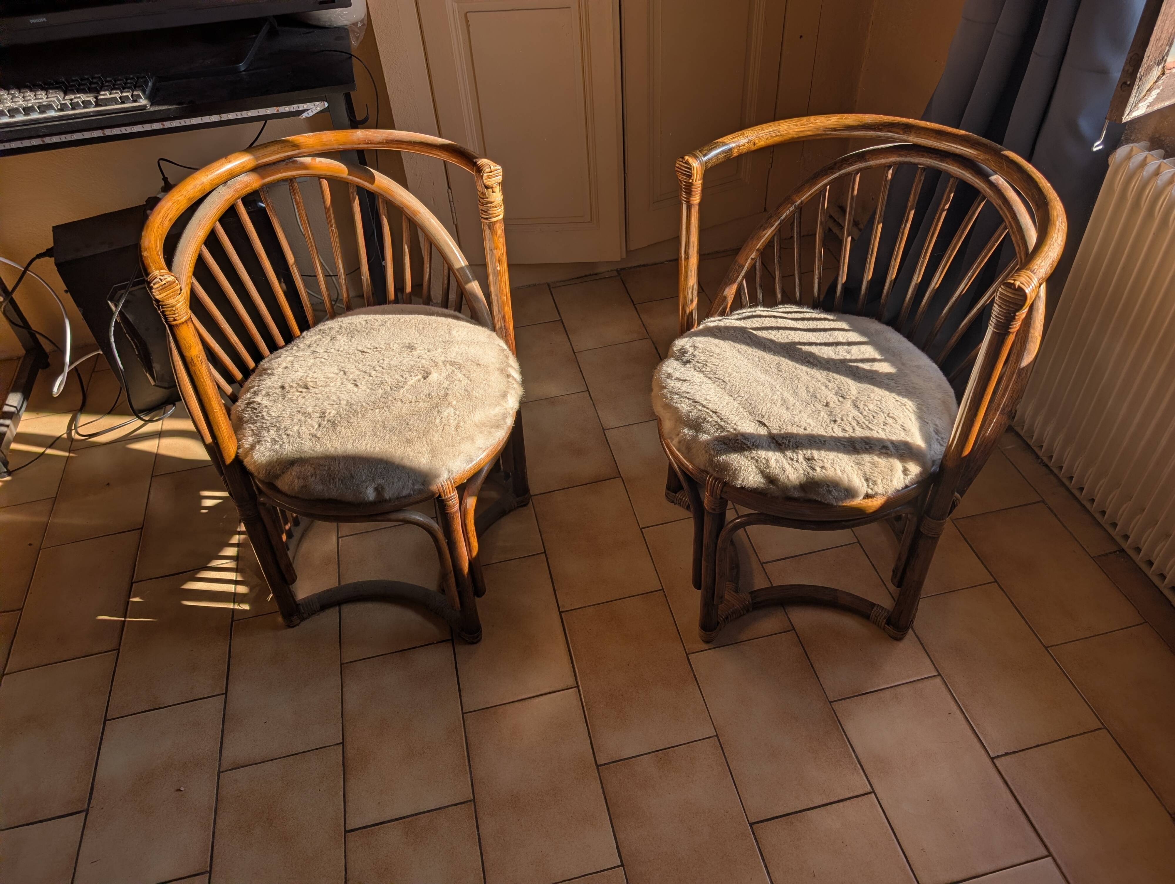 Pair of vintage rattan armchairs with soft fabric seats