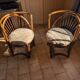 Pair of vintage rattan armchairs with soft fabric seats