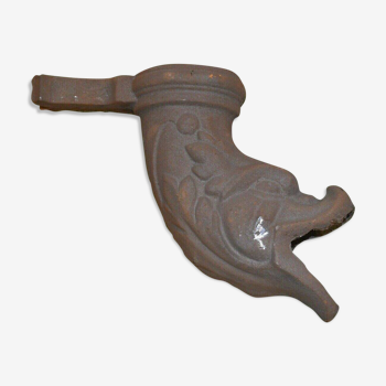 Cast iron gutter downspout in the shape of a dolphin