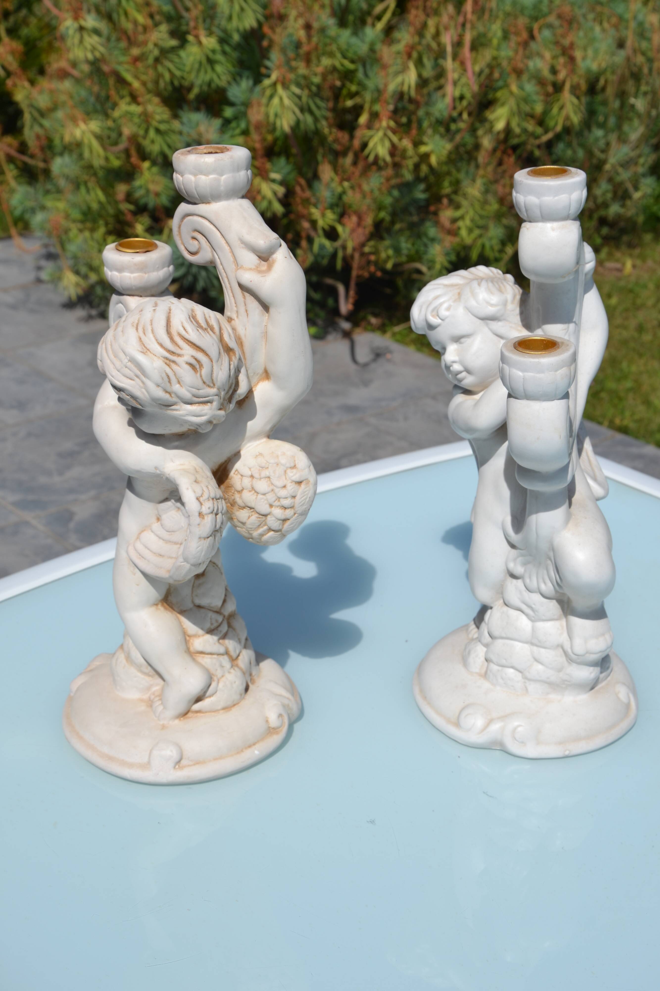 Pair of "cherub" candle holders in plaster