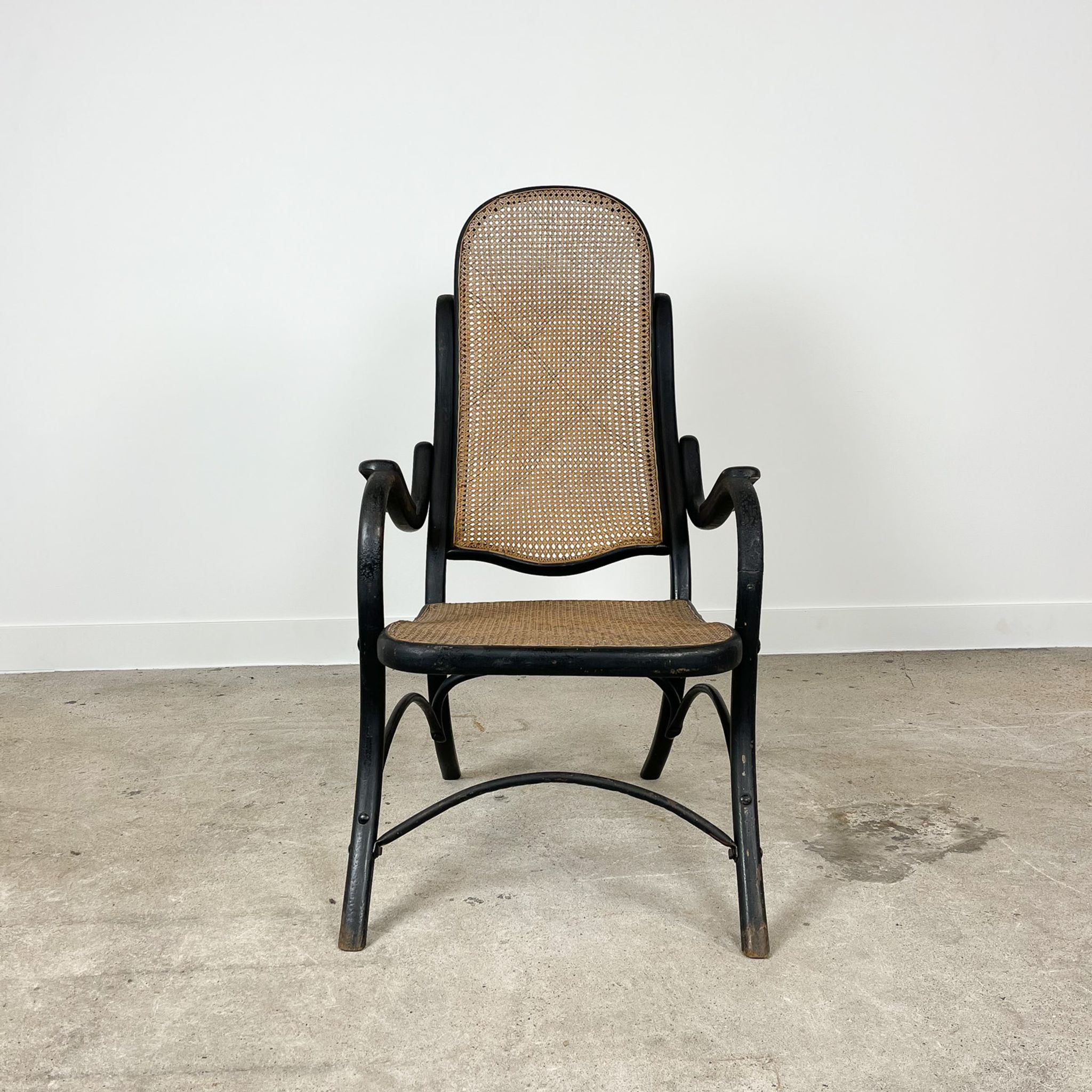 Antique black bentwood and cane lounge armchair by Thonet 19th century