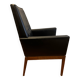 Modernist armchair in wood and black synthetic leather, circa 1960