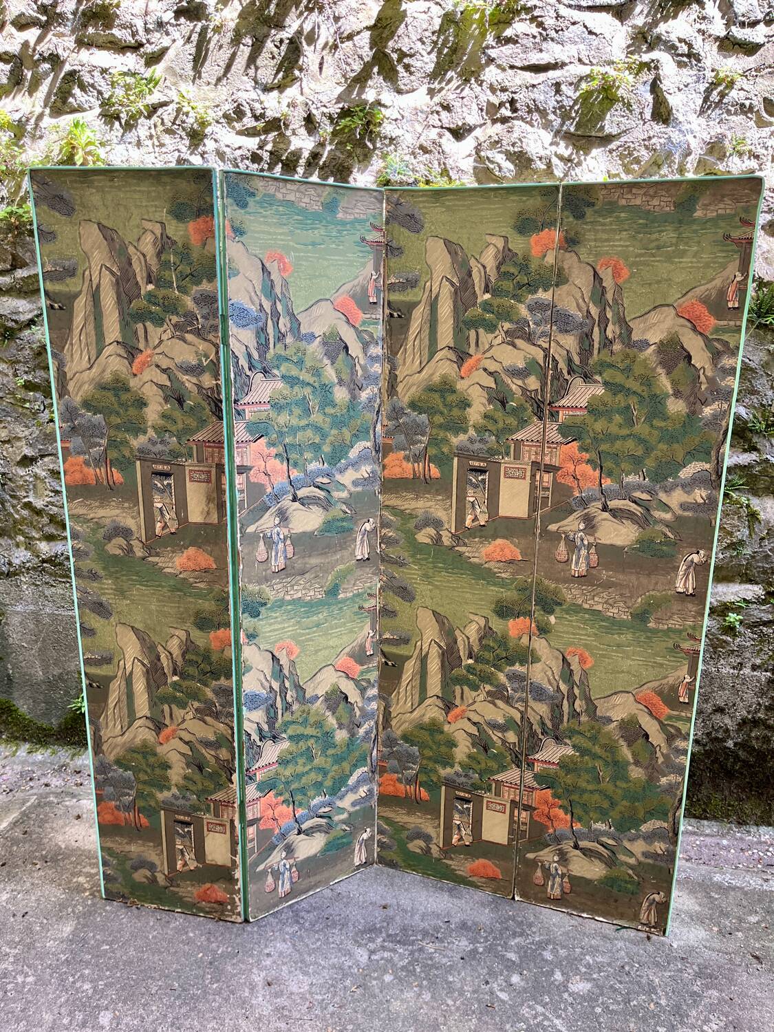 Wooden screen in Asian style, covered with Chinese wallpaper.