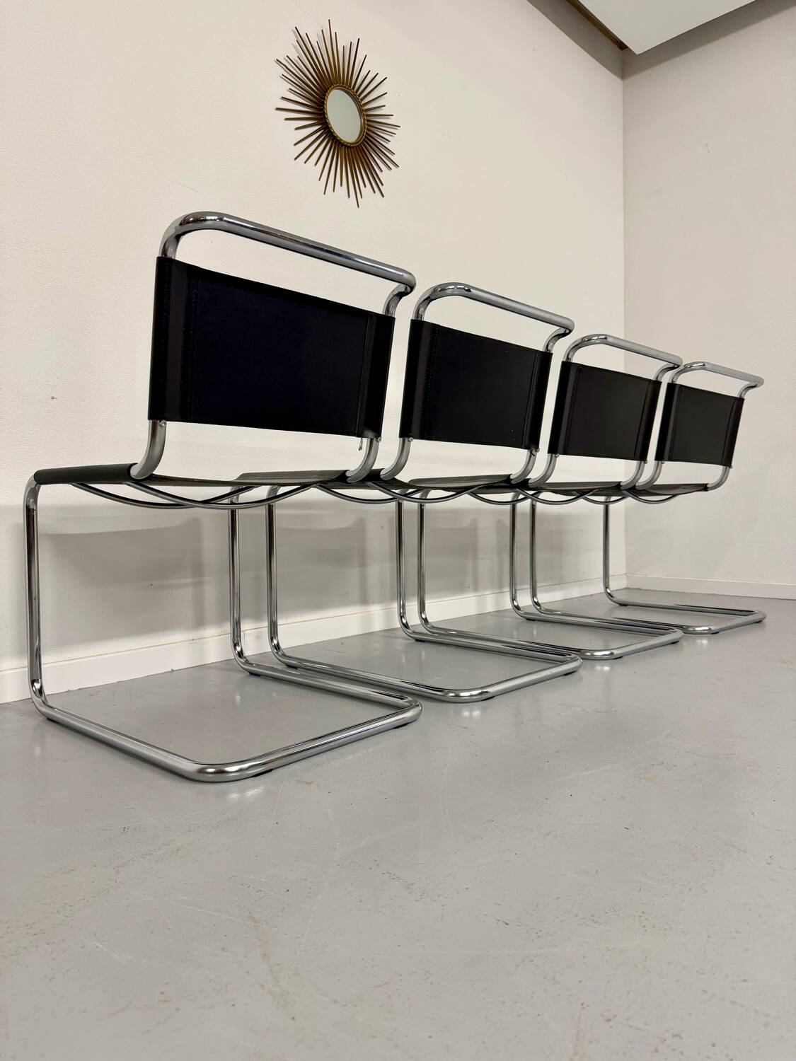 Lot of 4 tubular chairs designed by Mart Stam in vintage black leather from the 1980s.