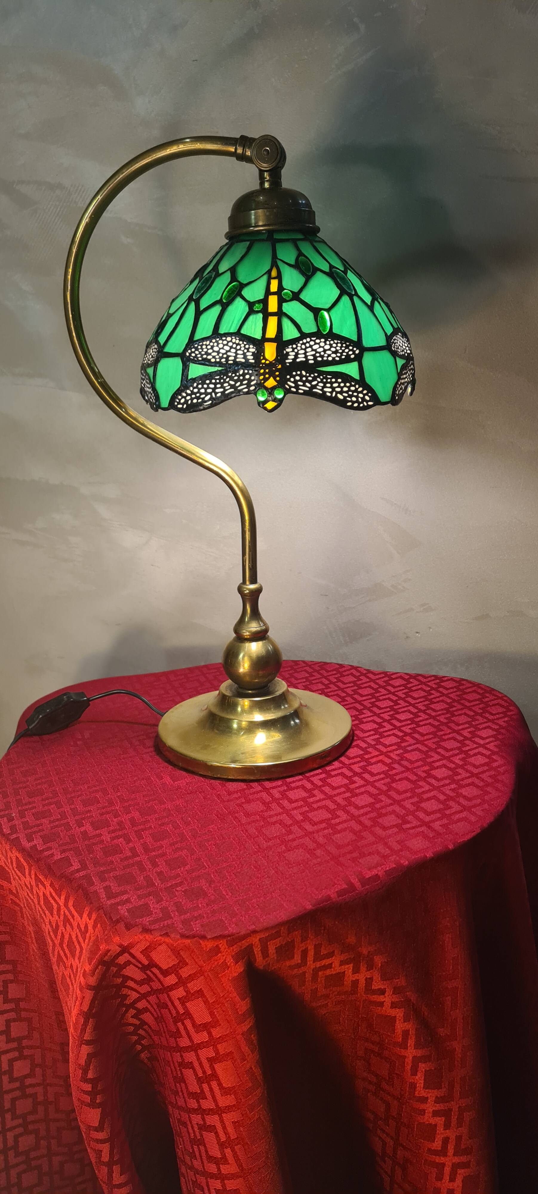 brass lamp with green stained glass shade.