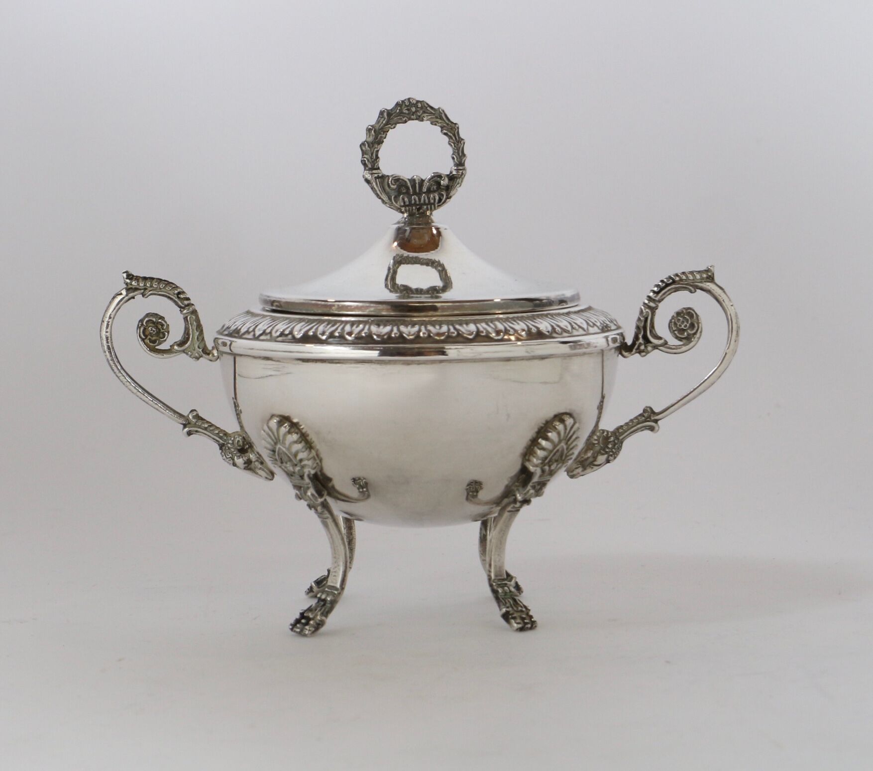 Silver sugar bowl with paw feet and ornate handles