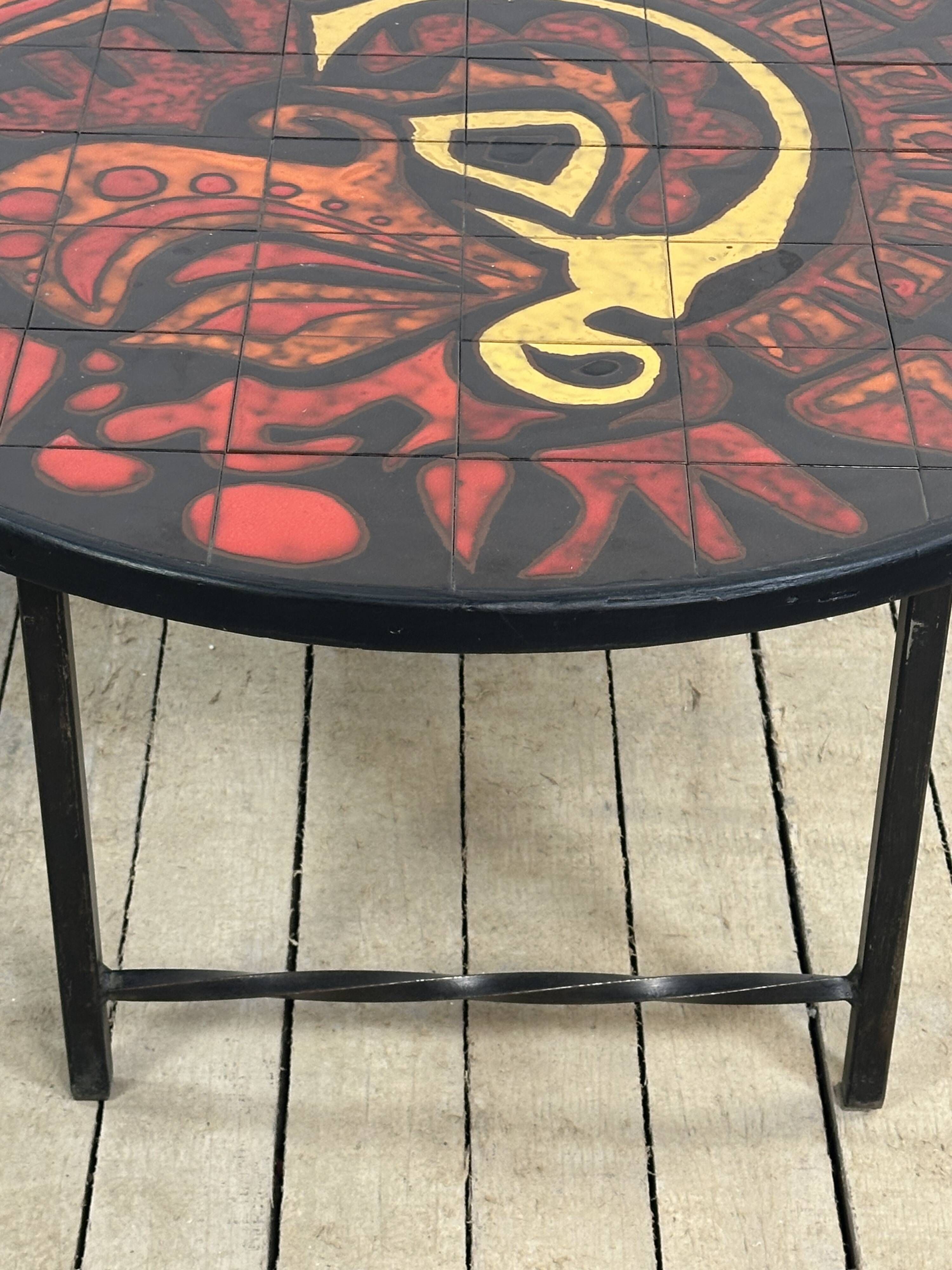 Vintage round coffee table in graphic red and yellow ceramic from the 1960s.