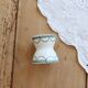Old diabolo egg cup, ironstone with ivory and green pattern.