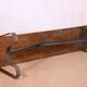 Old bench in Burmese teak with a wrought iron base.