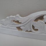 Decorative pediment in white carved wood