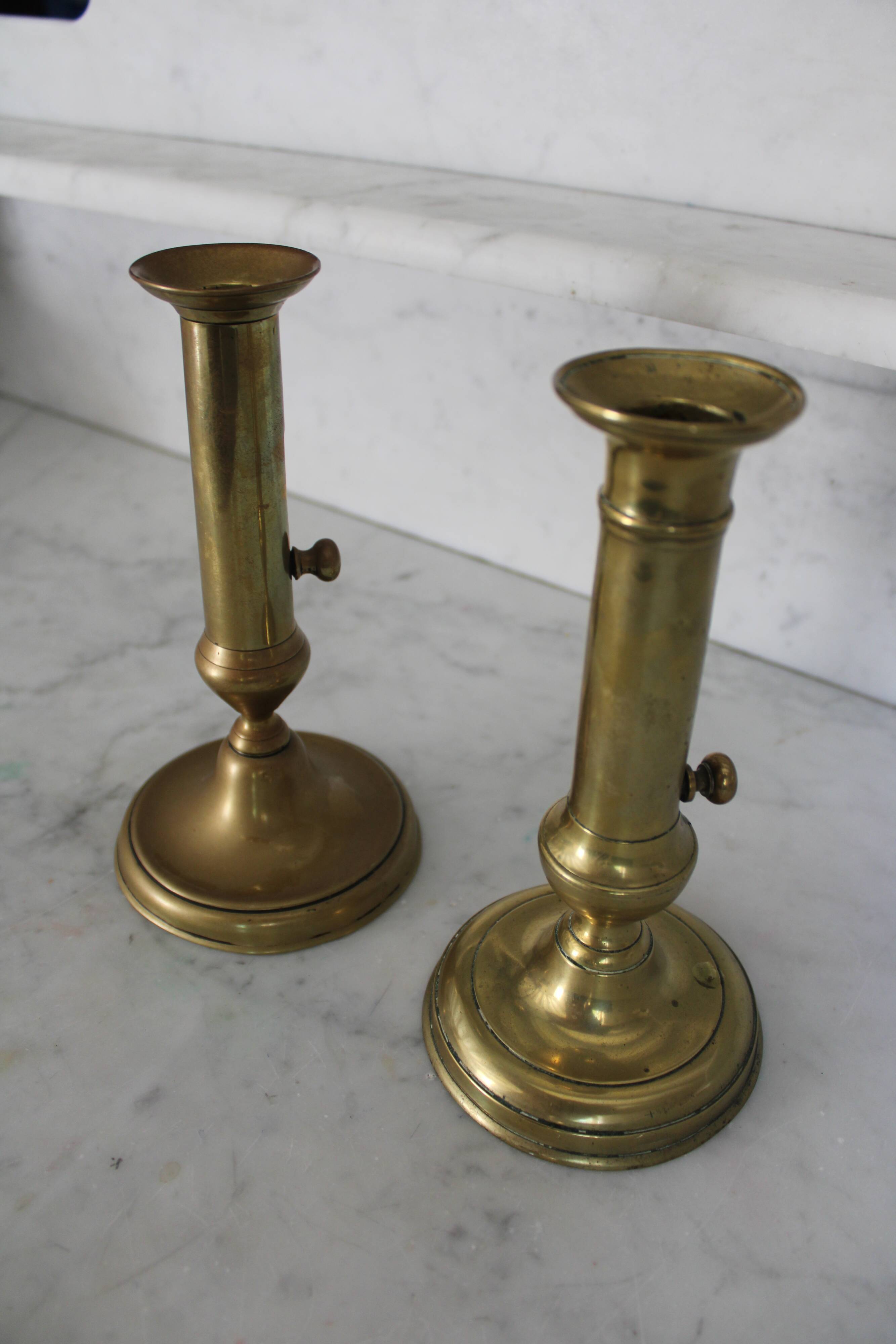 Pair of brass pusher candlesticks