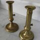 Pair of brass pusher candlesticks