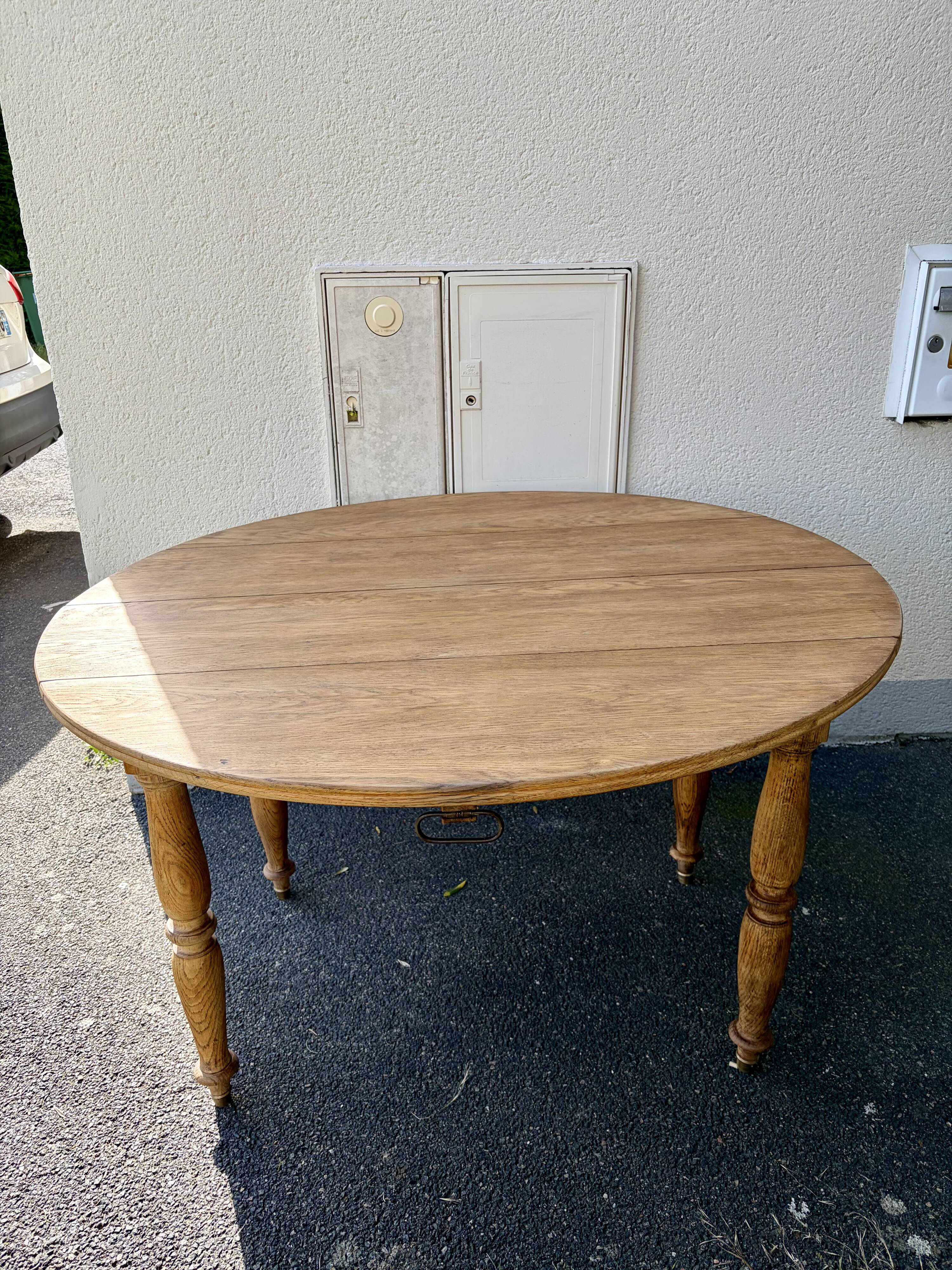 Round oak table with a drop leaf.
