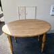 Round oak table with a drop leaf.