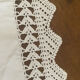 Antique white cotton pillowcase with crochet and monogram.